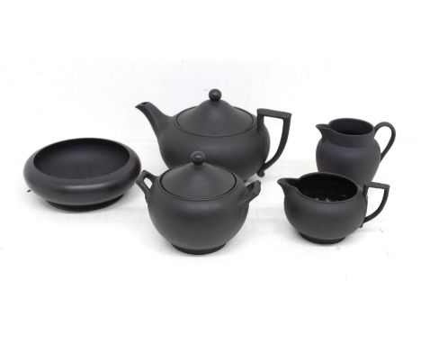 Wedgwood Black Basalt collection comprising teapot and cover, 2 x cream jugs, sugar bowl and cover and shallow bowl. Height o