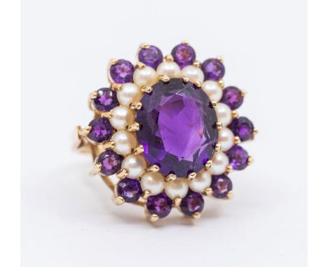 An amethyst and pearl 9ct gold cluster ring, central oval mixed cut amethyst within a border of half pearls and outer border 