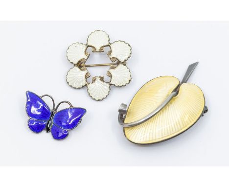 Volmer Bahner: a collection of three Danish silver gilt enamel brooches to include a yellow guilloche enamel domed leaf, alon