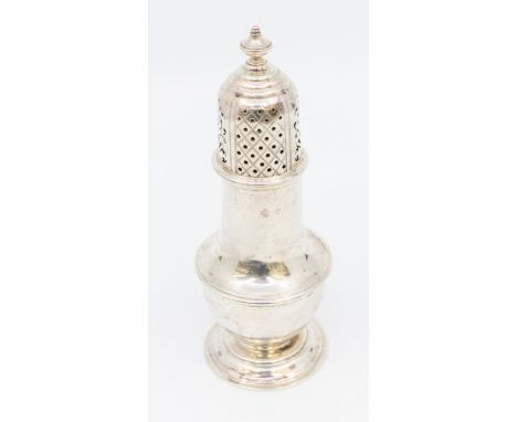 A George II style silver baluster shaped caster, pierced dome cover with urn shaped finial, the body with mid rib on spreadin