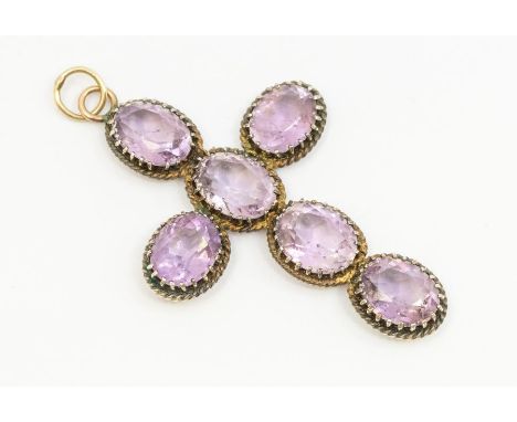 Interesting ProvenanceA silver and amethyst set cross, comprising oval mixed cut amethysts, claw set within fancy rope twist 