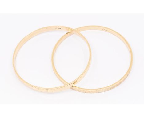 A 9ct gold rectangular section bangle, hammer finish, width approx 5mm, along with another with bark effect texture, width ap