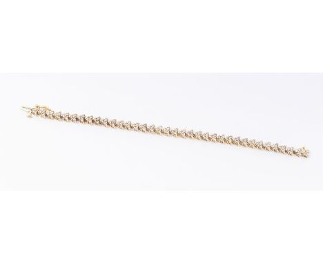 A diamond and 9ct gold bracelet, comprising arrow shaped links, each link claw set with three round brilliant cut champagne d