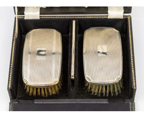 A matched pair of Modern silver mounted engine turned clothes brushes and comb, hallmarked by Barker &amp; Co, Birmingham, 19