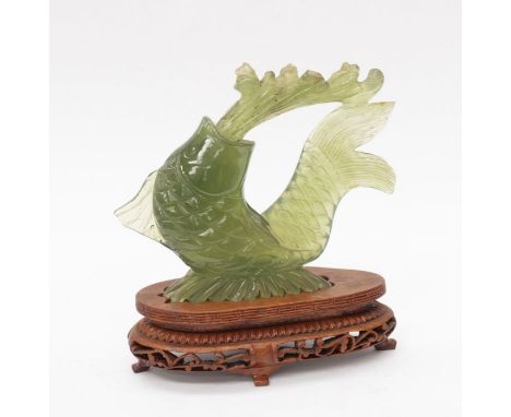 A jade Chinese Koy Carp, on a hardwood stand