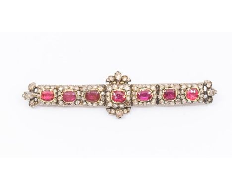 A 19th century diamond and garnet topped red paste set bar brooch, comprising a row of red round/oval cut red paste set in go