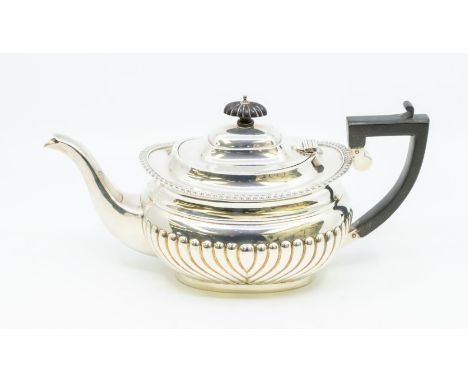 A Georgian style silver teapot, gadroon border and lower section, ebonised finial and handle, hallmarked by GN/RH, Chester, 1