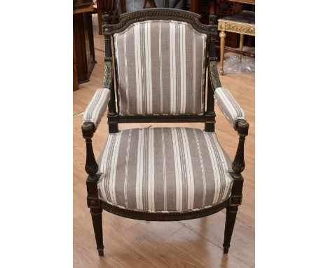A late 18th Century early 19th Century ebonised Regency armchair with finial back rest, gilt detail foliage, detail column le