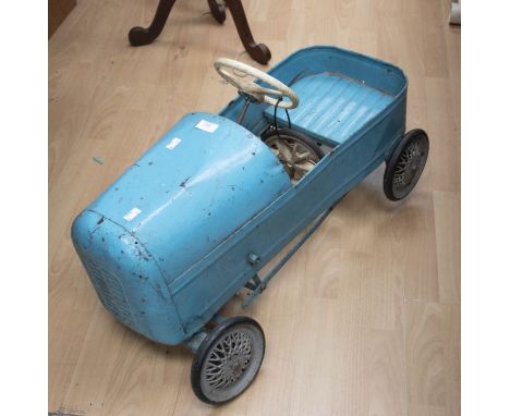 A vintage child's peddle car