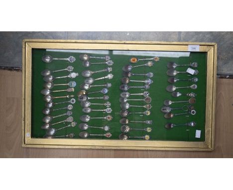 A collection of 73 white metal and enamel souvenir spoons, held in two box frames (2)&nbsp;