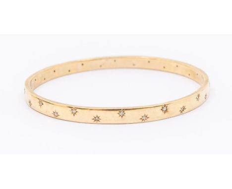 A diamond set 9ct gold bangle, rectangular section approx 6mm,  set with star set small round brilliant cut diamonds, interna