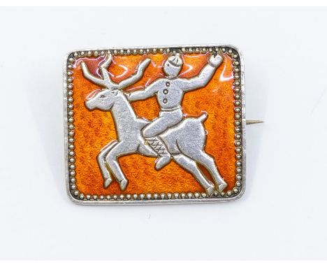 Ivar Holth: a silver and enamel brooch with a Inuit and reindeer silver decoration over an orange enamel ground, square form,
