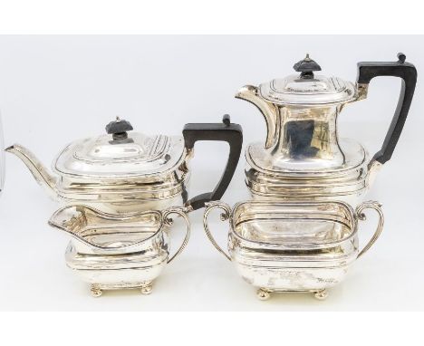 A matched George V silver four piece tea service including teapot, hotwater jug, sugar bowl and milk jug, plain bodies on bun