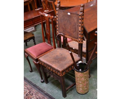 A carved oak and leather chair; another; a bureau; mirror; an umbrella walking stick; umbrellas, sticks etc. 