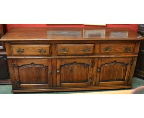 A Titchmarsh and Goodwin style sideboard, moulded top, three short drawers over three fielded panel door cupboard. 80cm high 