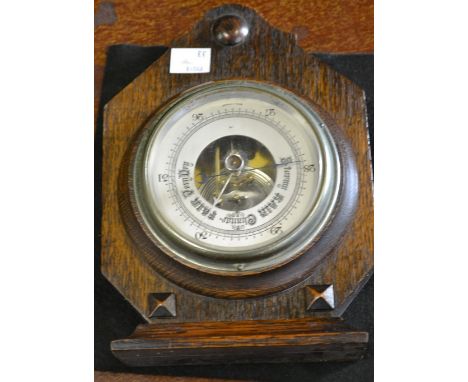 An Art Deco oak aneroid barometer