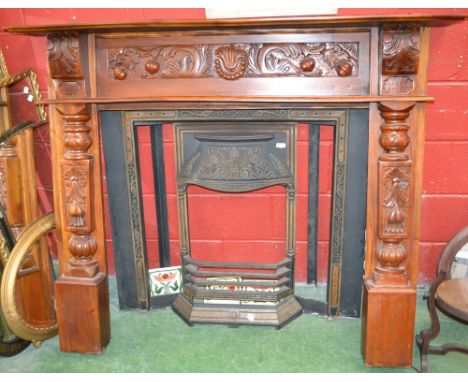 A reproduction cast metal tile surround fireplace, teak mantel 