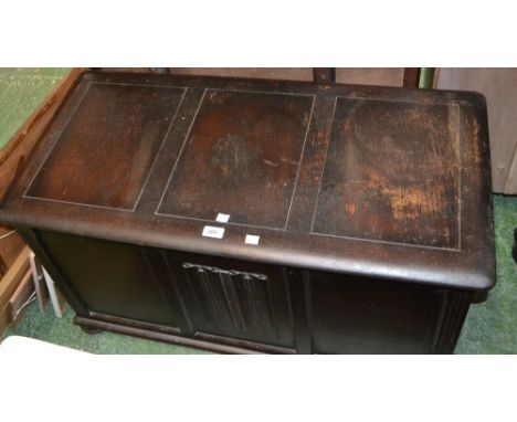 An oak blanket box, linenfold panel to front