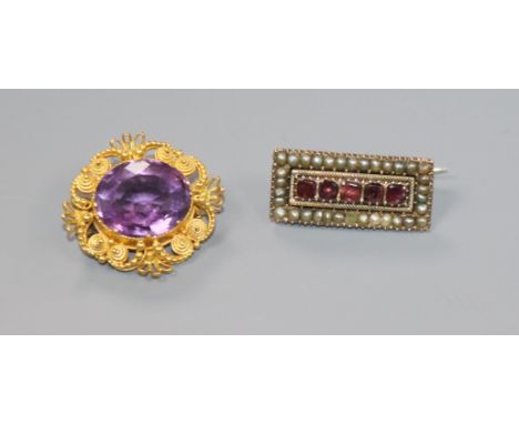 A Victorian yellow metal and amethyst cannetile work brooch and a Victorian garnet and split pearl set brooch.