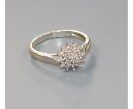 A modern 9ct white gold and diamond cluster ring, size K.