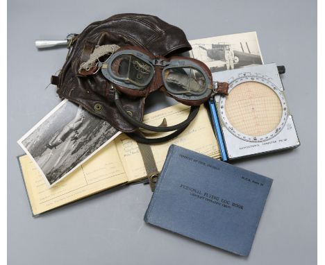 Two Pilots log books for W/S Lieutenant Jack Leonard Rushburne, South Africa Air Force, together with a leather flying helmet