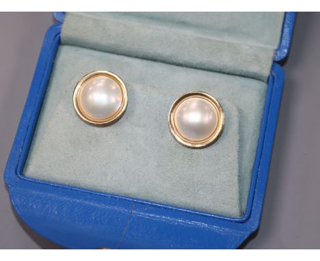 A pair of 9ct yellow gold and mabe pearl target earrings.