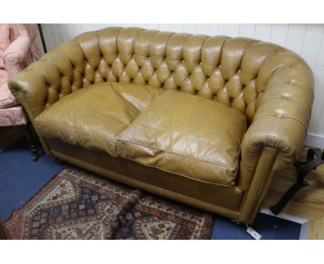 A small buttoned leather Chesterfield sofa W.150cm