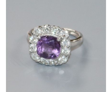 A modern 9ct white gold, amethyst and diamond cluster ring, size J/K.