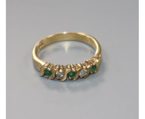 A modern 9ct gold, emerald and diamond five stone half hoop ring, size K.