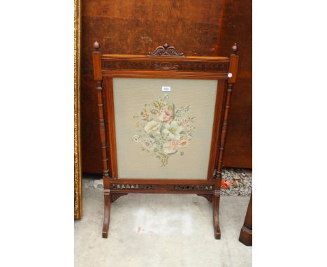 A MAHOGANY LATE VICTORIAN FIRESCREEN WITH FLORAL WOOLWORK PANEL 