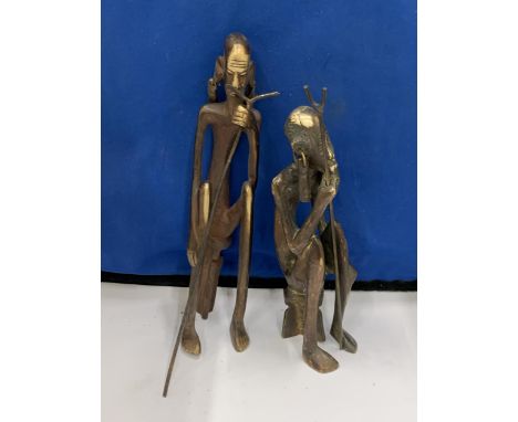 TWO BRONZE AFRICAN SEATED MEN FIGURES WITH WALKING STICKS 