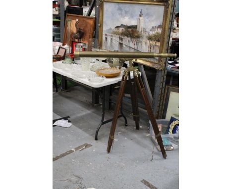 A VINTAGE BRASS TELESCOPE ON A WOOD AND BRASS TRIPOD 