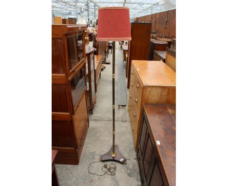 A BRASS STANDARD LAMP ON PLATFORM BASE WITH CLAW FEET, COMPLETE WITH SHADE 