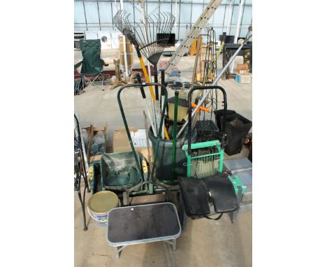A LARGE ASSORTMENT OF GARDEN TOOLS TO INCLUDE A MOWER, A SACK TRUCK AND RAKES ETC 