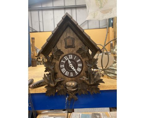 A LARGE VINTAGE CHAIN DRIVEN CUCKOO CLOCK 