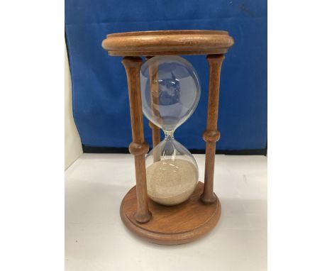 A LARGE WOODEN GLASS EGG TIMER 