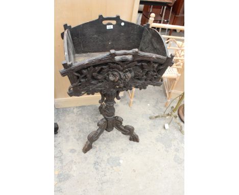 A 19TH CENTURY BLACK FOREST PLANTER WITH CARVED FRONT ON SHAPED TRIPOD COLUMN, 38" HIGH 