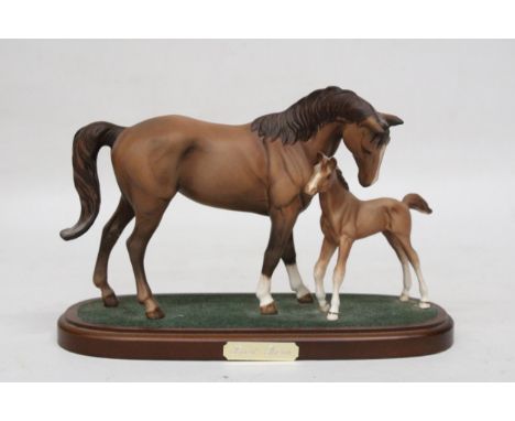 A BESWICK MODEL OF A MARE AND FOAL 'FIRST BORN' ON A PLINTH 