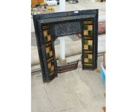 A VINTAGE DECORATIVE CAST IRON AND TILED FIRE SURROUND 