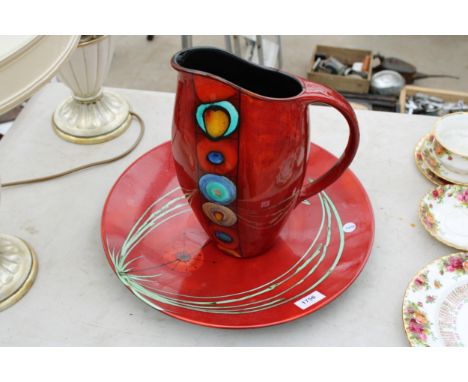A LARGE RED POOLE POTTERY WASH JUG AND A FURTHER RED PLATE 