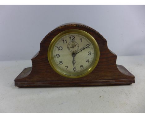 AN OAK CARVED MANTEL CLOCK, 9.5CM SILVERED DIAL 