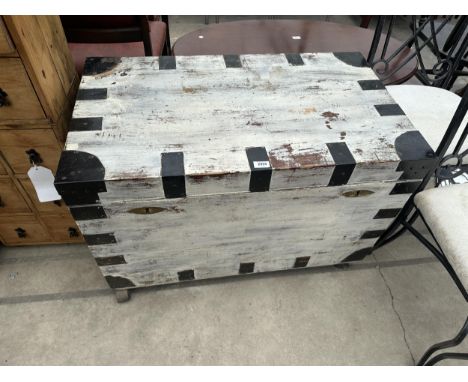 A METAL BANDED TRUNK, 36" X 21" ON CASTERS 