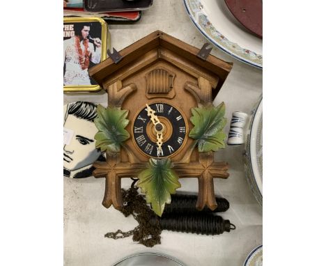 A SMALL VINTAGE CHAIN DRIVEN CUCKOO CLOCK 