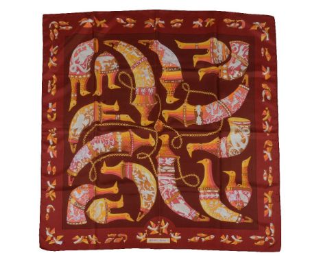 Hermes, Rhytons, a silk scarf, designed by Karin Swildens, bird head topped rhytons upon a burgundy ground, with rolled edges