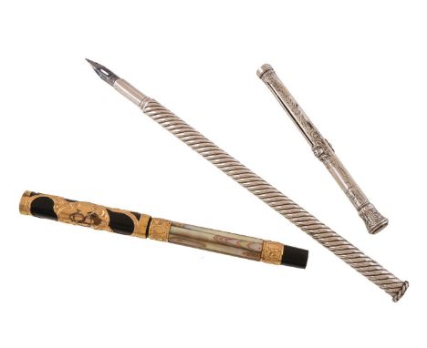 ϒ A black lacquer and mother of pearl fountain pen, the cap with gilt metal overlaid scroll decoration and engraved CR, the f