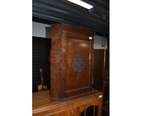 An oak corner cupboard of small proportions, having engraved front, L &amp; R (M?)