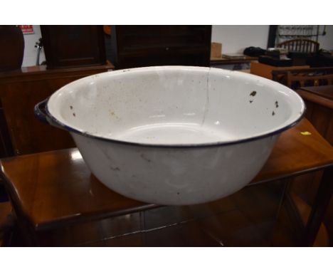 A large enamel wash bowl in blue and white
