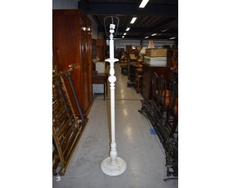A vintage white painted standard lamp