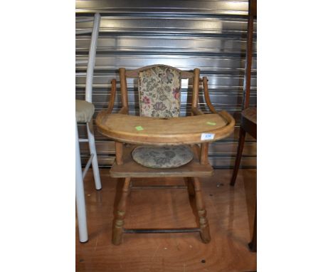 A vintage childrens low high chair with potty seat
