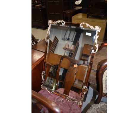 A vintage wall mirror, having peach glass and gilt foliate surround